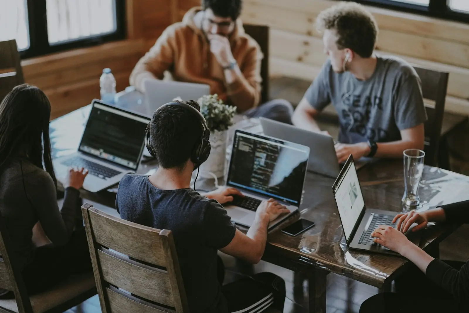 Software developers collaborating on laptops