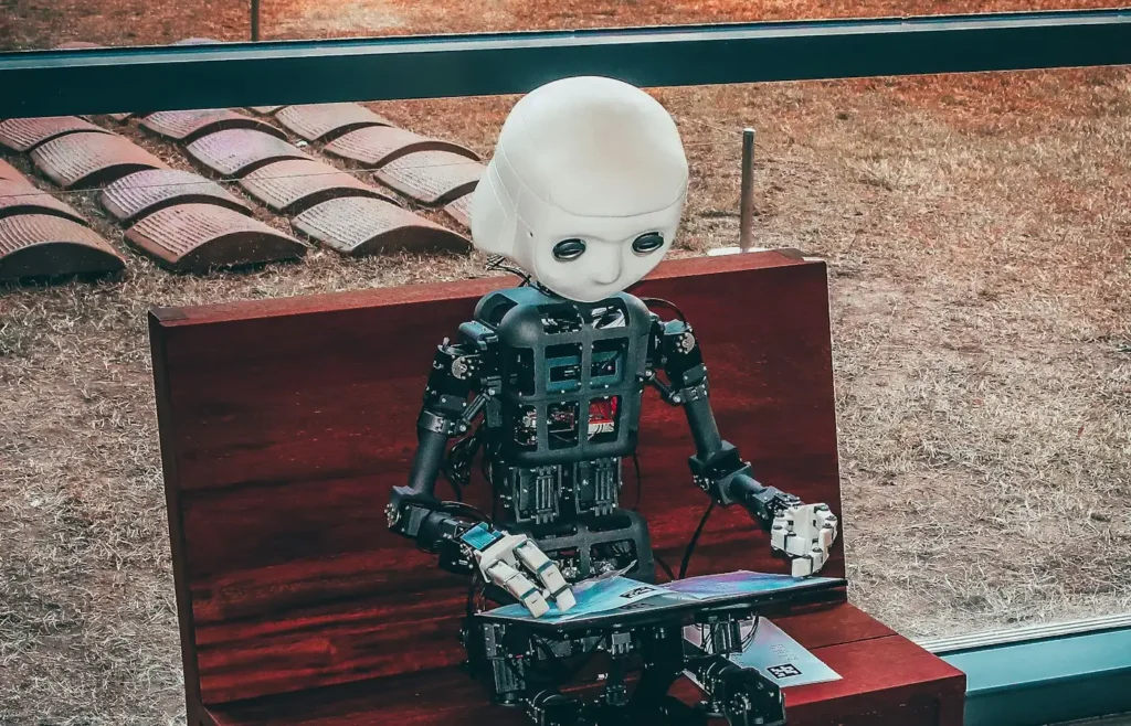 A small robot using a laptop