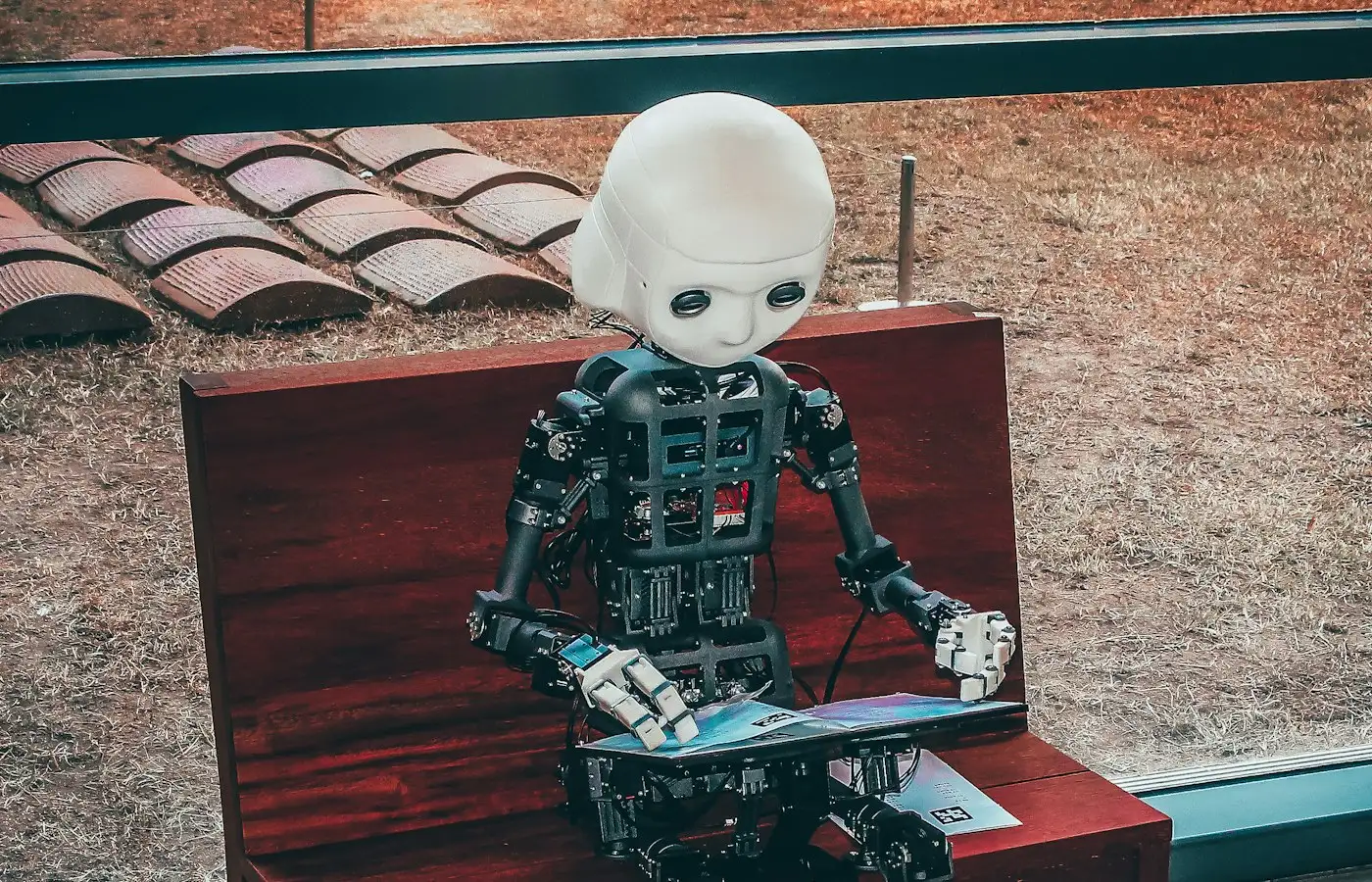 A small robot using a laptop