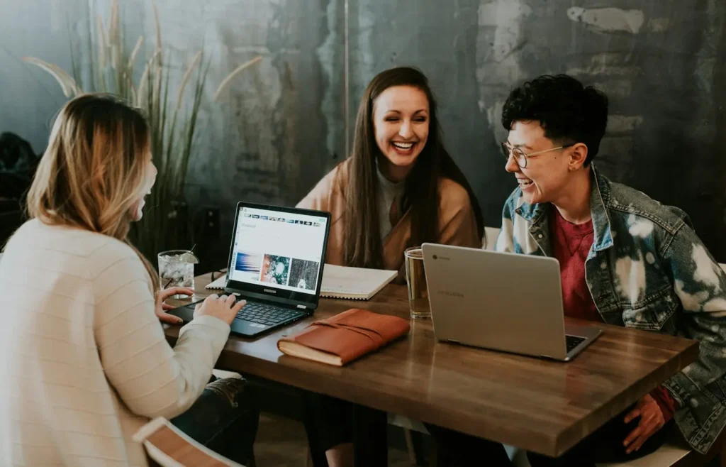 A team collaborating around laptops